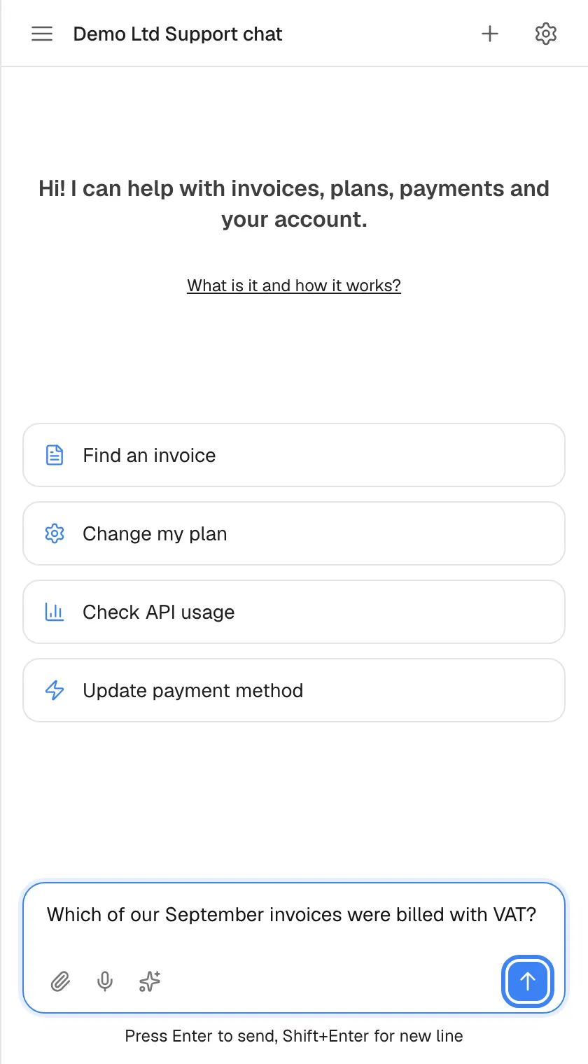 The welcome screen with a question typed into the message box: "Which of our September invoices were billed with VAT?". The blue send button with an up arrow at the right of the box, labelled "Send message", is highlighted and active. To the left are the paperclip for attachments, the microphone for voice input and the sparkle icon for prompt shortcuts. Pressing Enter also sends; Shift+Enter starts a new line.