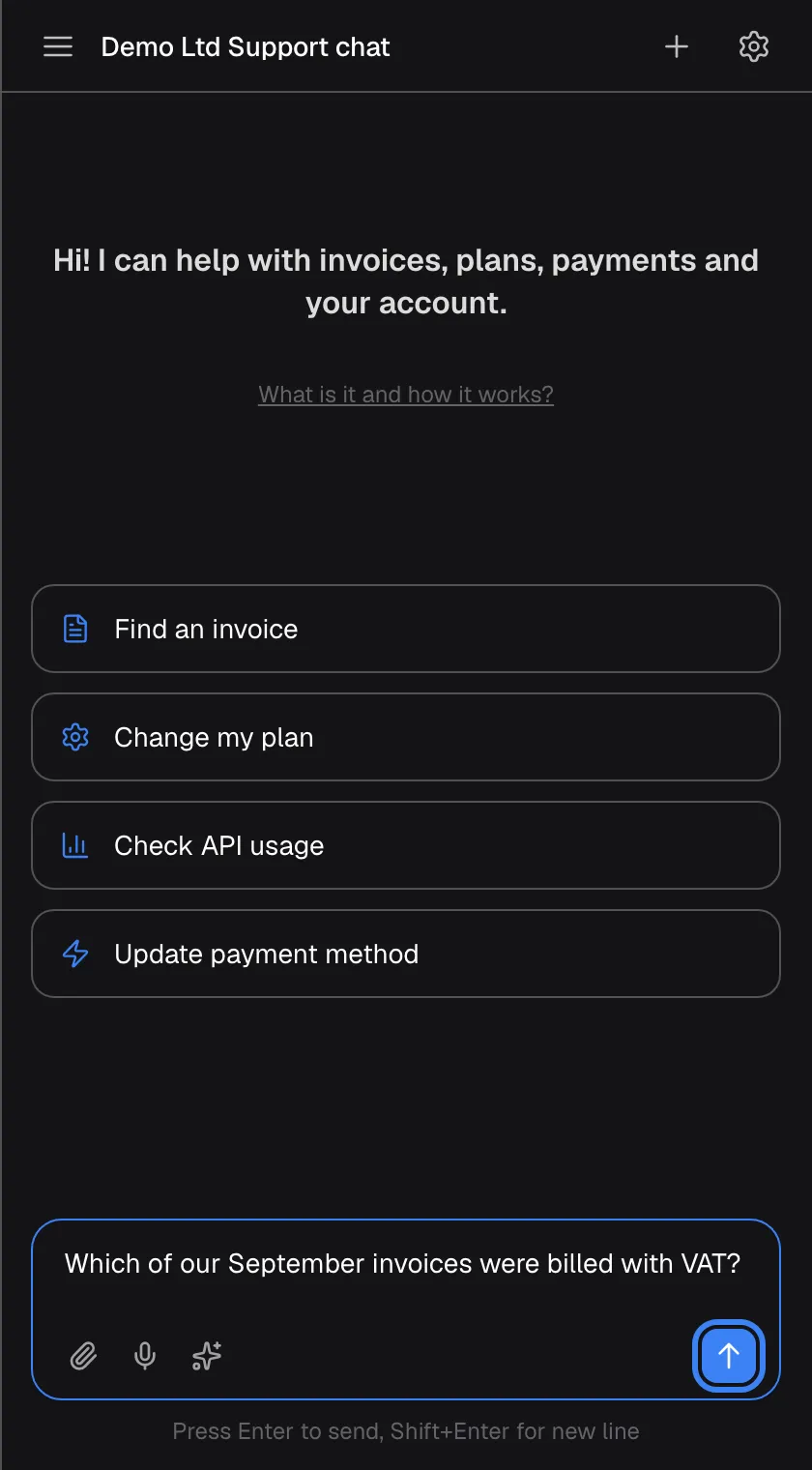 The welcome screen with a question typed into the message box: "Which of our September invoices were billed with VAT?". The blue send button with an up arrow at the right of the box, labelled "Send message", is highlighted and active. To the left are the paperclip for attachments, the microphone for voice input and the sparkle icon for prompt shortcuts. Pressing Enter also sends; Shift+Enter starts a new line.